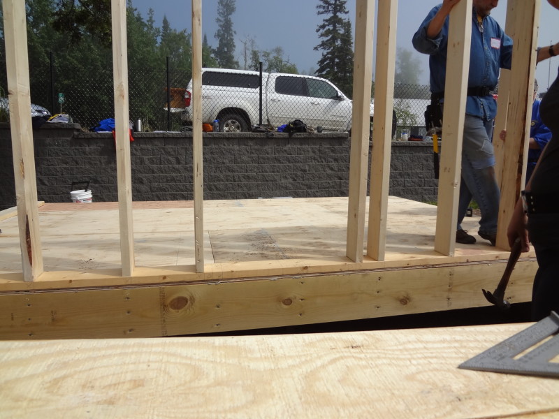 Notice how studs are aligned with floor joists (vertical rows of nails along rim joist). The two studs that are not aligned with floor joists are for framing the window.