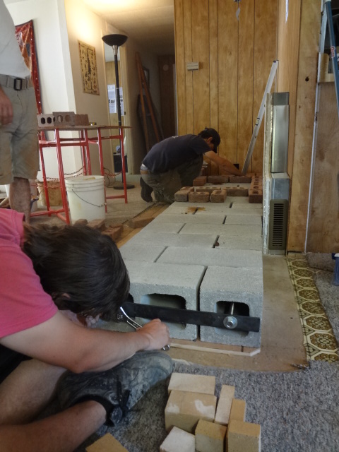 All-threads were placed into the ciderblocks holes, and tightened over a steel bar to hold the foundation together as one piece.