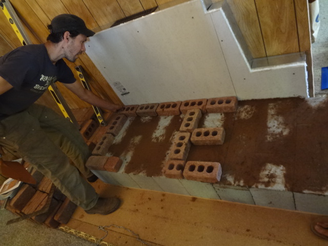 1st row of red brick laid in place.