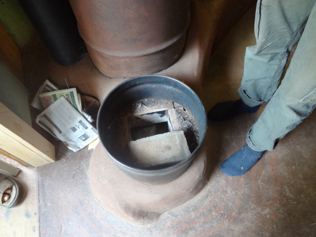 Wood for the fire is fed vertically in the small barrel