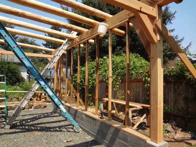Outer row of wall studs in place. An inner row of studs was added next with small horizontal connecting pieces,forming a "ladder truss" system.