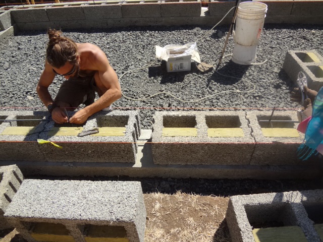 Laying down more horizontal rebar between layers of Faswall blocks